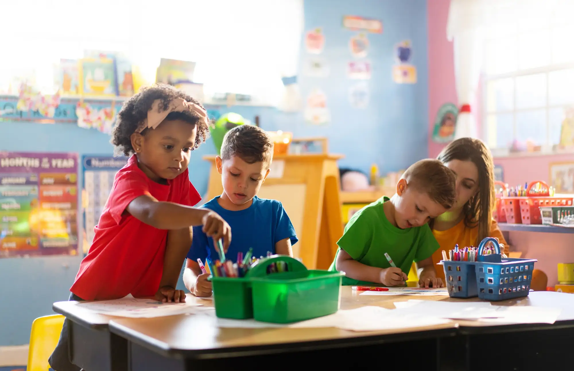 Children working together at a table in a bright classroom